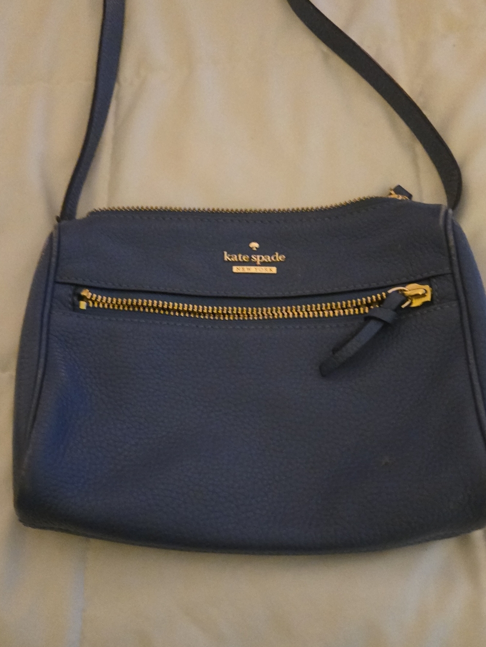 kate spade dark blue purse. it has a few signs of wear,